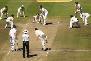 Nathan Lyon bowls to Kyle Abbott with plenty of catchers on the final morning in Cape Town © Getty Images