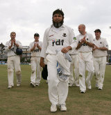 Mushtaq Ahmed leads Sussex off after taking 13 wickets in the match © Getty Images