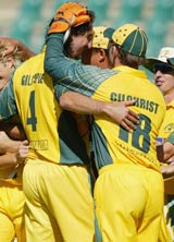 Jason Gillespie is hugged by his teammates after he picked up five wickets against Zimbabwe © Getty Images